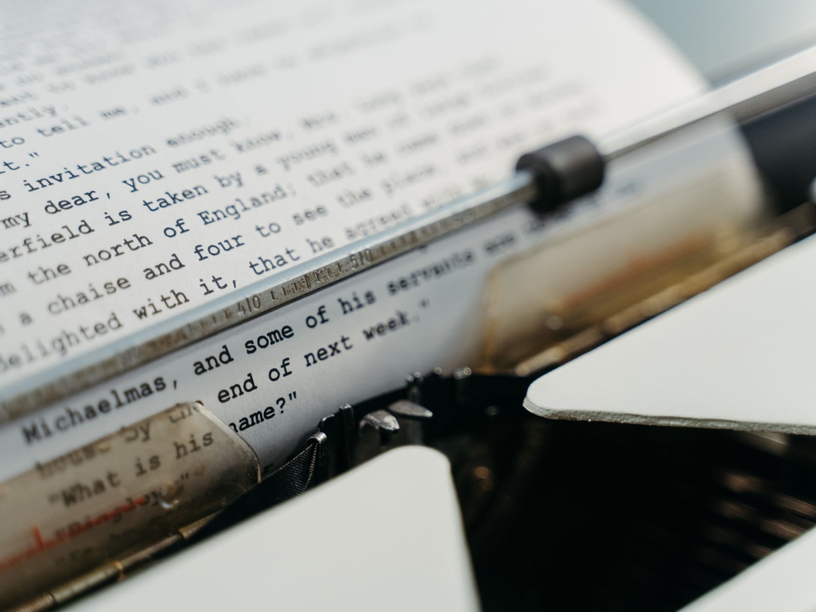 Close-up of a professional editor proofreading a printed manuscript with a pencil