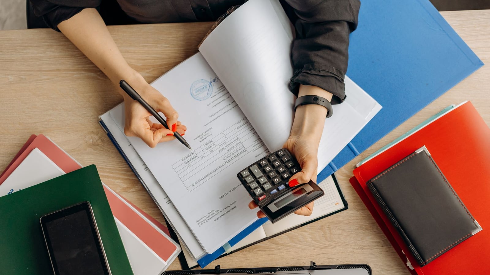 Professional business tools on a wooden desk representing editorial pricing